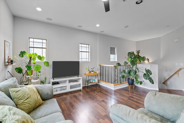 living room with ceiling fan and dark hardwood / wood-style flooring