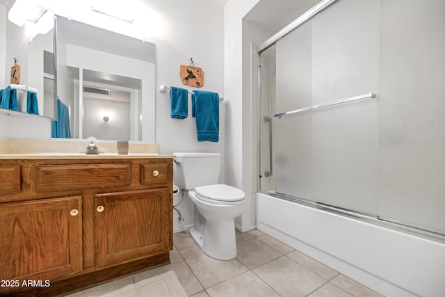 full bathroom featuring vanity, baseboards, enclosed tub / shower combo, tile patterned floors, and toilet