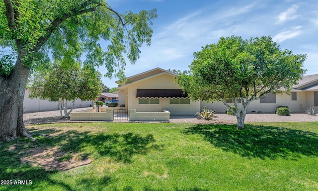 view of front of house featuring a front yard and fence