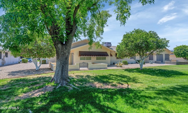 obstructed view of property with a front yard