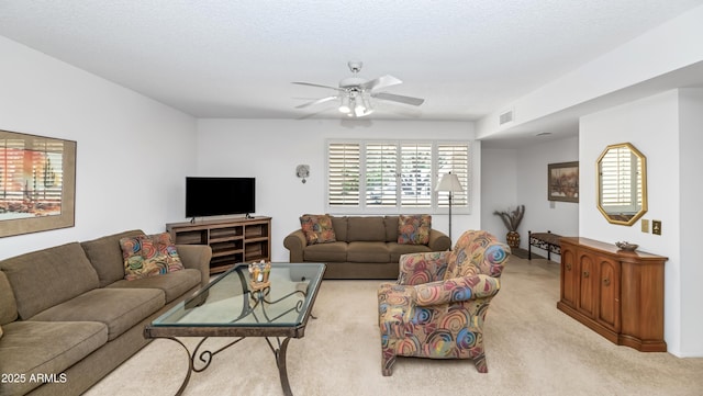 living room featuring visible vents, ceiling fan, and light colored carpet