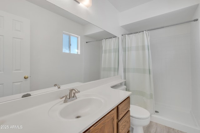 bathroom featuring vanity, toilet, and a tile shower