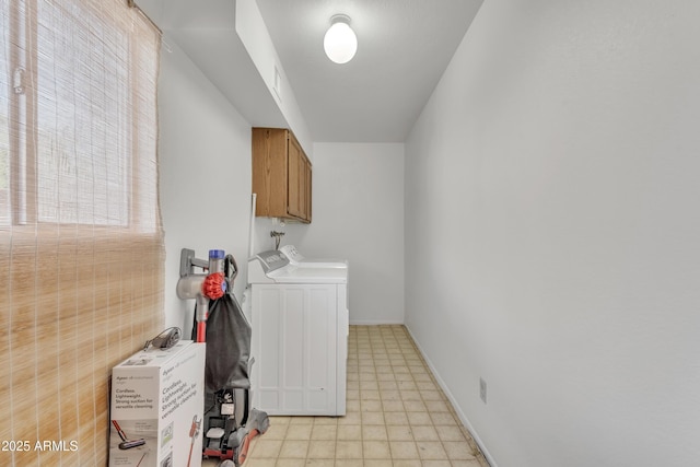 clothes washing area with cabinet space, light floors, independent washer and dryer, and baseboards