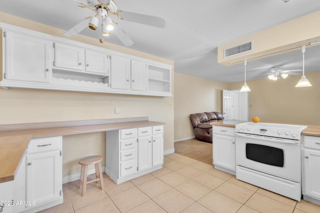 kitchen featuring visible vents, light tile patterned floors, white electric range oven, built in study area, and open shelves