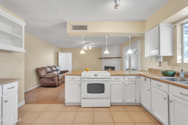 kitchen with light tile patterned floors, open floor plan, visible vents, and white electric range