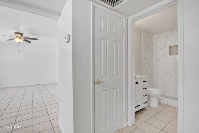 bathroom featuring ceiling fan, vanity, tile patterned flooring, and toilet