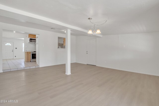 interior space with a notable chandelier and light hardwood / wood-style flooring