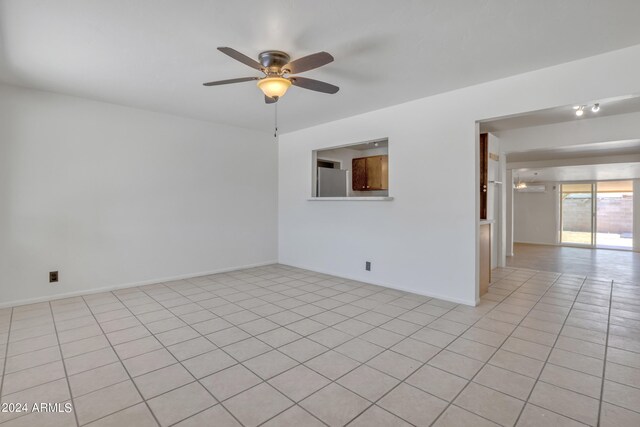 unfurnished room featuring light tile patterned flooring and ceiling fan