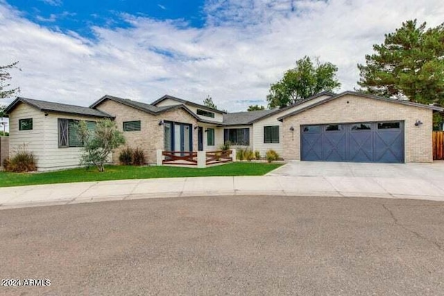 single story home with a garage and a front lawn