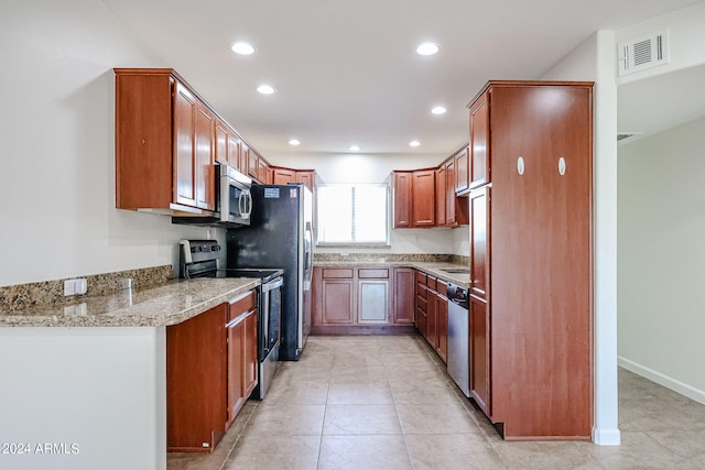 kitchen with light tile patterned floors and stainless steel appliances