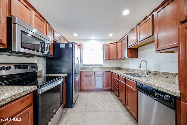 kitchen with light tile patterned floors, stainless steel appliances, and sink