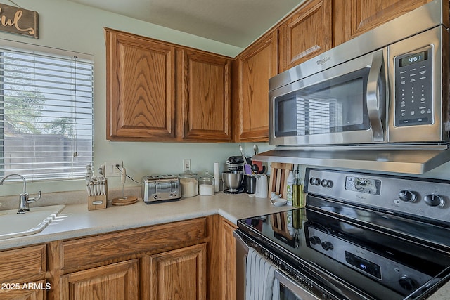 11101 E Abilene Ave, Mesa, AZ 85208 - kitchen featuring appliances with stainless steel finishes, light countertops, and brown cabinetry