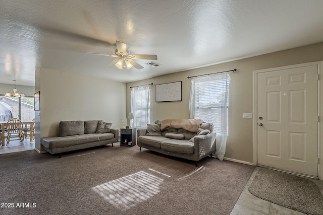 11101 E Abilene Ave, Mesa, AZ 85208 - tiled living room with healthy amount of natural light, ceiling fan, and carpet floors