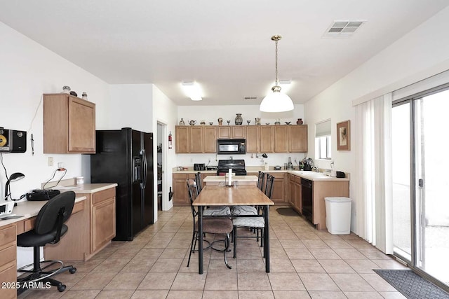 kitchen featuring light tile patterned floors, black appliances, and sink