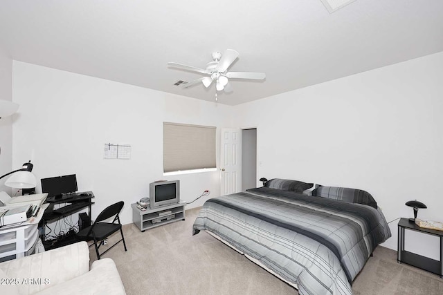 bedroom with ceiling fan and light carpet