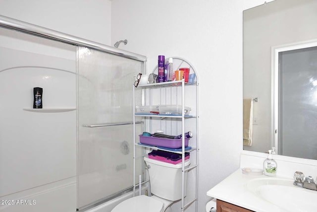 full bathroom featuring bath / shower combo with glass door, vanity, and toilet