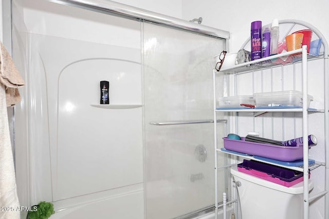 bathroom featuring combined bath / shower with glass door