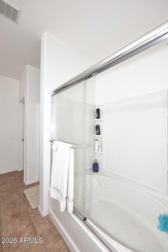 bathroom with independent shower and bath and tile patterned flooring