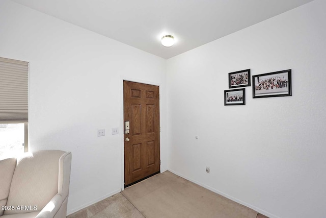 view of carpeted foyer entrance