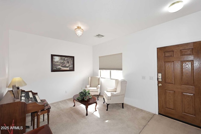 sitting room featuring light colored carpet