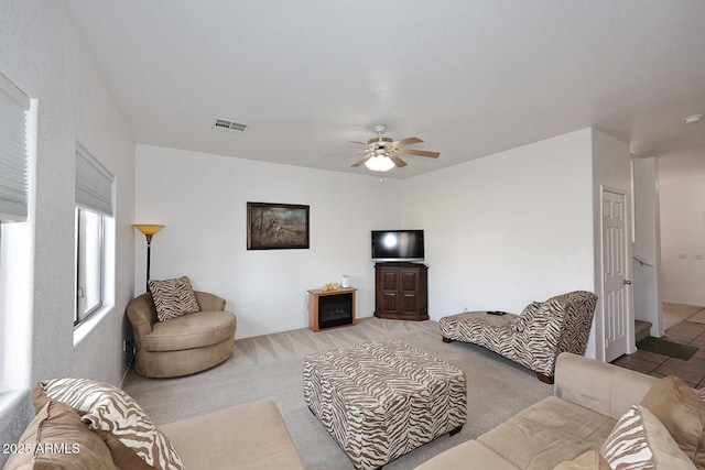 living room with light colored carpet and ceiling fan