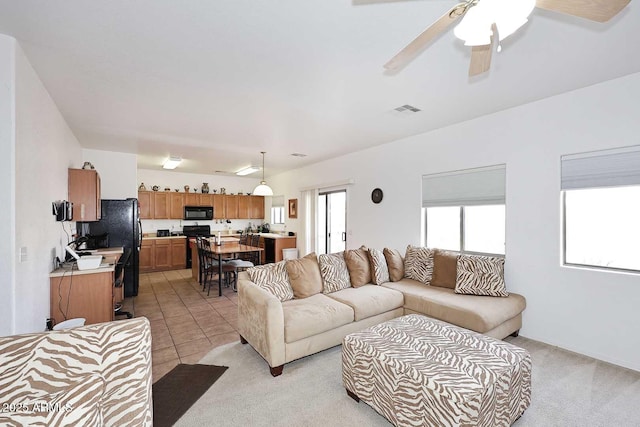 tiled living room featuring ceiling fan