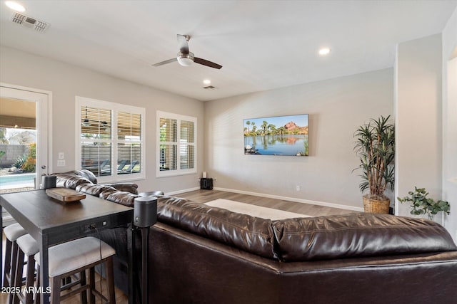 24403 N 43rd Dr, Glendale, AZ 85310 - living area featuring visible vents, baseboards, a ceiling fan, and wood finished floors