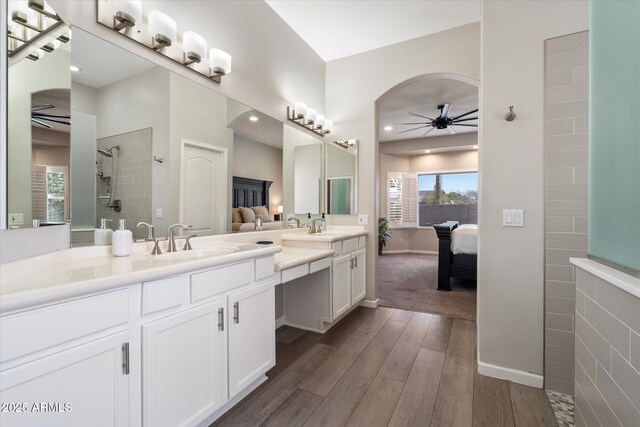 24403 N 43rd Dr, Glendale, AZ 85310 - ensuite bathroom featuring ensuite bath, a ceiling fan, wood finished floors, a sink, and walk in shower