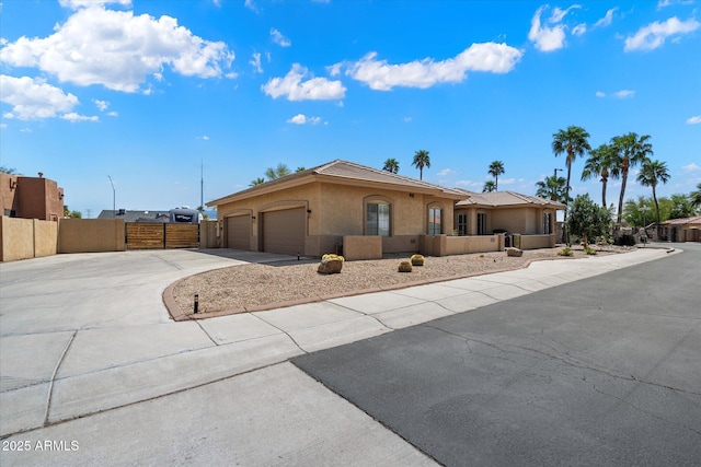 24403 N 43rd Dr, Glendale, AZ 85310 - view of front of house with stucco siding, a gate, driveway, a garage, and fence