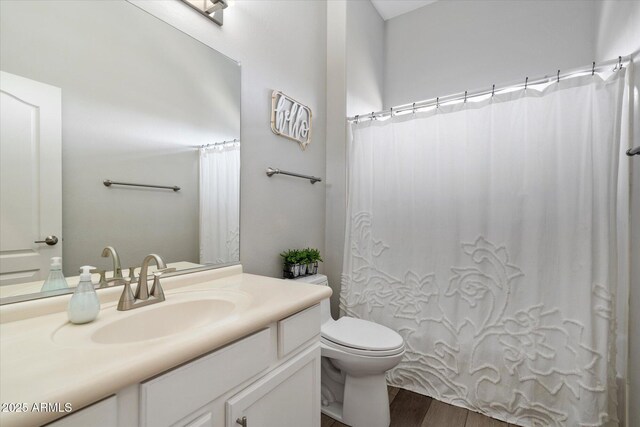 24403 N 43rd Dr, Glendale, AZ 85310 - full bath with toilet, a shower with shower curtain, vanity, and wood finished floors