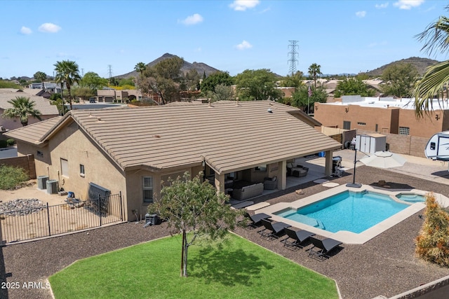 24403 N 43rd Dr, Glendale, AZ 85310 - view of swimming pool with central air condition unit, a yard, a patio area, a fenced backyard, and a pool with connected hot tub
