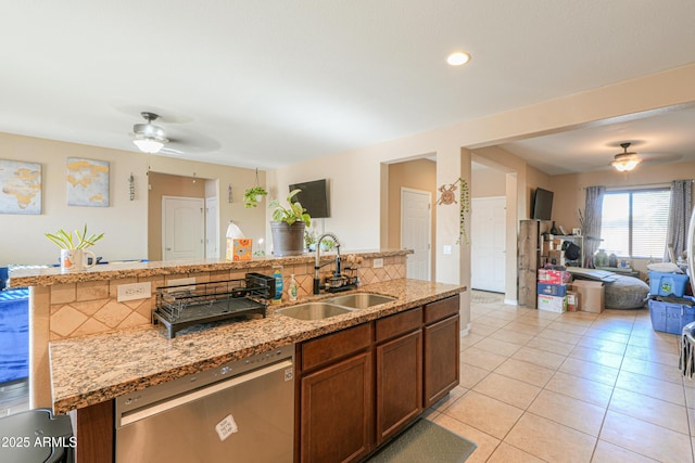 kitchen featuring a sink, ceiling fan, stainless steel dishwasher, and open floor plan