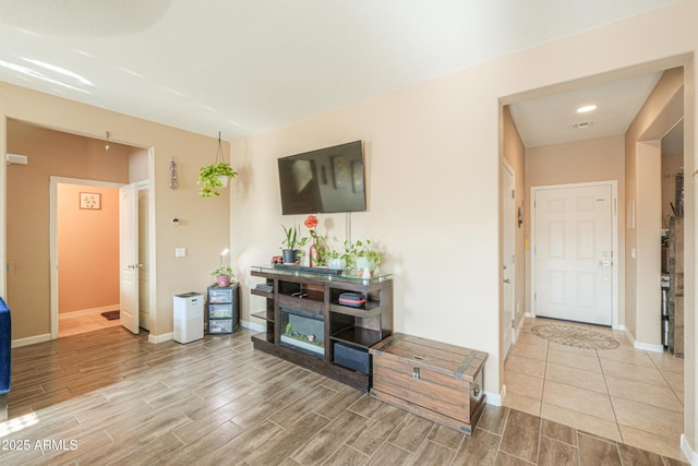 living room featuring baseboards, wood tiled floor, visible vents, and recessed lighting