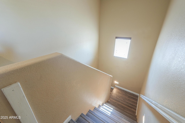 stairs featuring wood finished floors