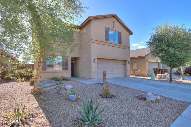 view of front of house featuring an attached garage, stucco siding, driveway, and a tile roof