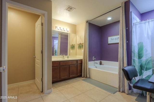 bathroom featuring vanity, tile patterned floors, baseboards, visible vents, and a bath