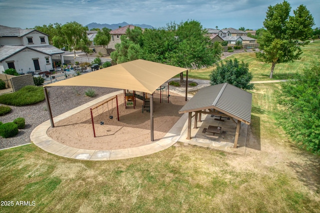 surrounding community with a residential view, fence, a lawn, and a playground