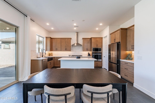 22822 E Watford Dr, Queen Creek, AZ 85142 - kitchen featuring a kitchen island, appliances with stainless steel finishes, wall chimney range hood, and decorative backsplash