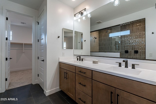 22822 E Watford Dr, Queen Creek, AZ 85142 - bathroom with visible vents, tiled shower, tile patterned flooring, and a sink
