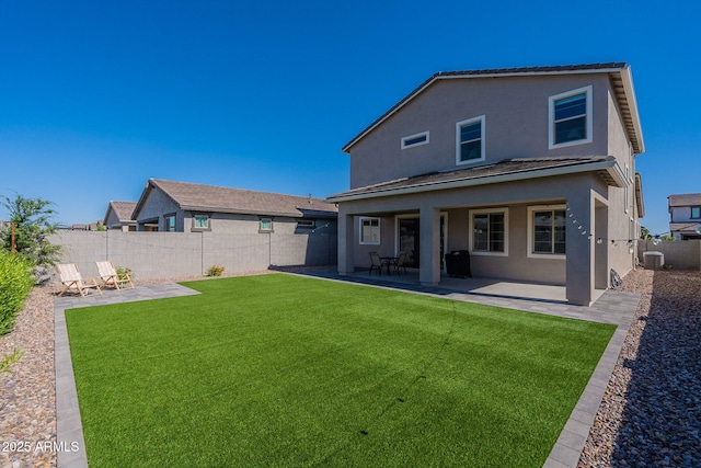 22822 E Watford Dr, Queen Creek, AZ 85142 - rear view of property with a fenced backyard, stucco siding, a patio, central AC, and a lawn