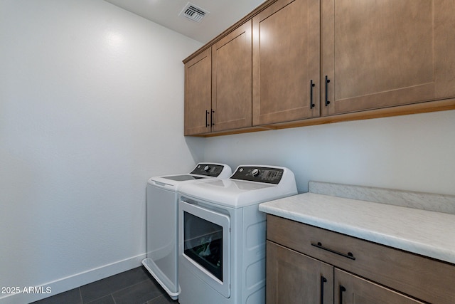 22822 E Watford Dr, Queen Creek, AZ 85142 - clothes washing area with cabinet space, washing machine and clothes dryer, visible vents, baseboards, and dark tile patterned flooring