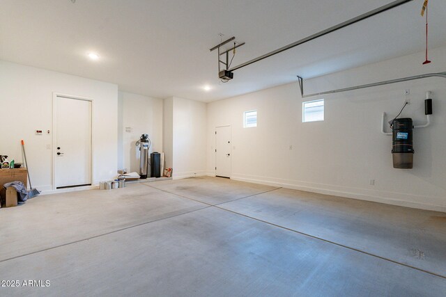 22822 E Watford Dr, Queen Creek, AZ 85142 - garage featuring a garage door opener, recessed lighting, and baseboards