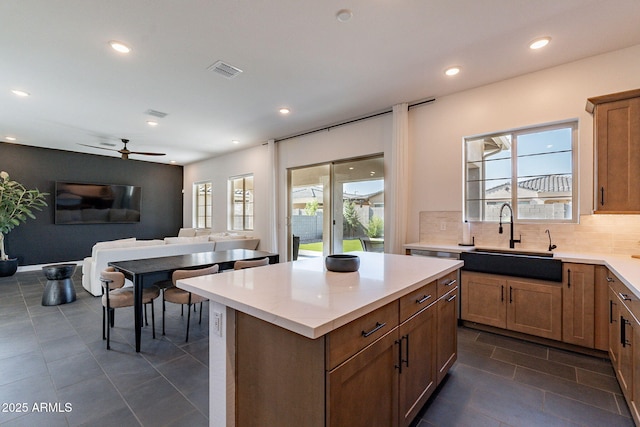 22822 E Watford Dr, Queen Creek, AZ 85142 - kitchen featuring a sink, visible vents, backsplash, dark tile patterned floors, and open floor plan