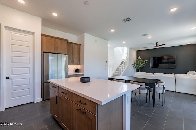 22822 E Watford Dr, Queen Creek, AZ 85142 - kitchen featuring freestanding refrigerator, a center island, visible vents, a ceiling fan, and open floor plan