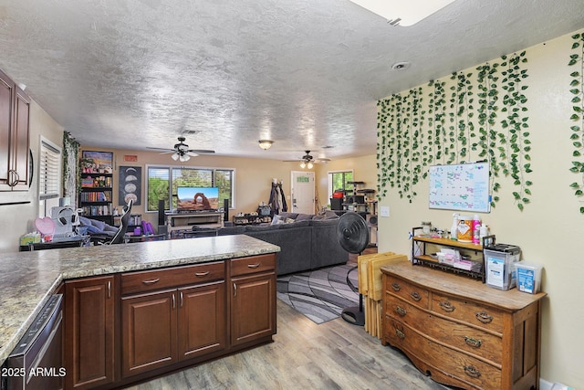 603 S Colcord Rd, Payson, AZ 85541 - kitchen featuring ceiling fan, dishwasher, light wood-style flooring, plenty of natural light, and a textured ceiling
