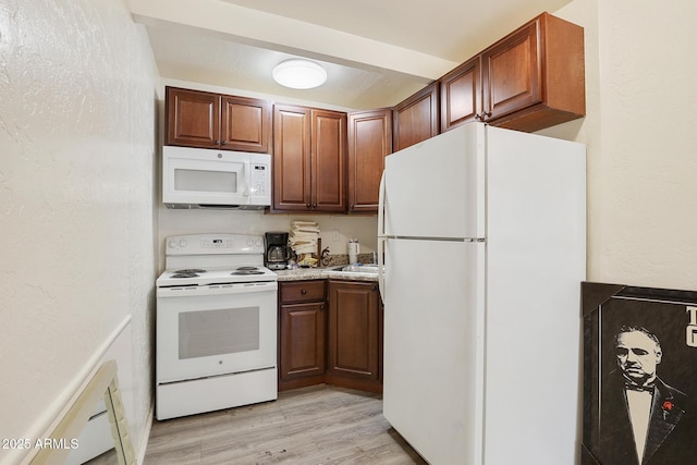 603 S Colcord Rd, Payson, AZ 85541 - kitchen with white appliances, light wood-type flooring, light countertops, and a sink