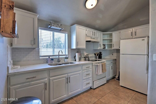 kitchen featuring sink, white cabinetry, vaulted ceiling, light tile patterned floors, and white appliances