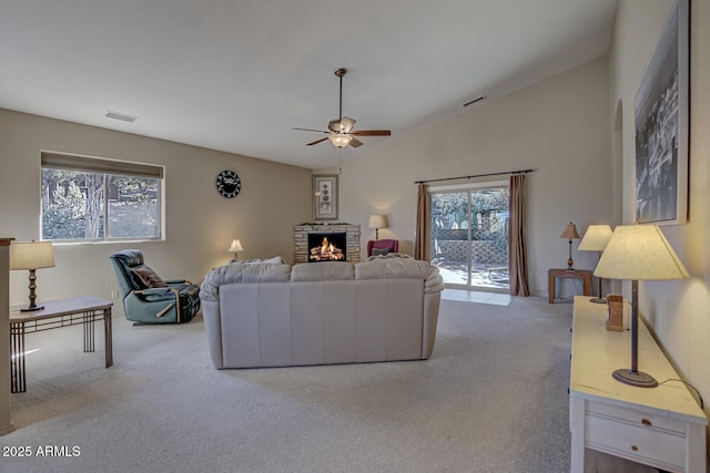 carpeted living room featuring lofted ceiling and ceiling fan