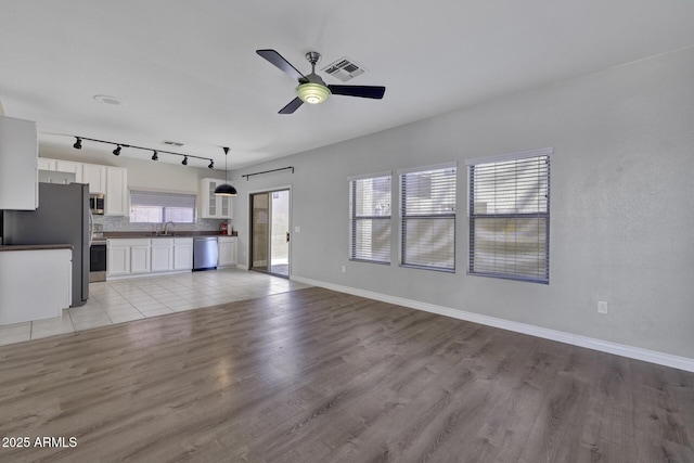1090 S Bogle Ct, Chandler, AZ 85286 - unfurnished living room with a ceiling fan and light wood finished floors