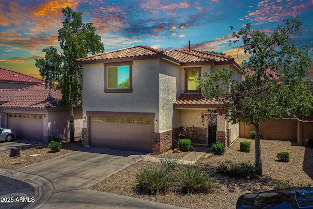 1090 S Bogle Ct, Chandler, AZ 85286 - mediterranean / spanish-style house featuring stucco siding, a garage, a tiled roof, driveway, and stone siding